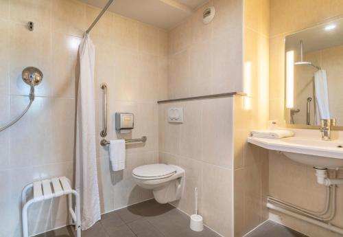 a bathroom with a toilet and a sink and a shower at B&B HOTEL Salon de Provence in Salon-de-Provence