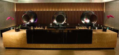 a restaurant with a counter with mirrors on the wall at Solaire Resort Entertainment City in Manila