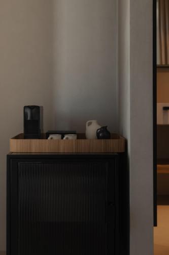 a wooden counter top with a microwave on top at Stamna Sifnos a member of Design Hotels in Sifnos