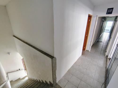 an empty hallway with a stairway in a building at Cobertura Duplex Próx da Praia in Recife