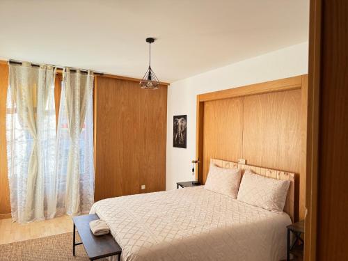 a bedroom with a large bed and a window at Votre oasis au cœur de Lausanne in Lausanne