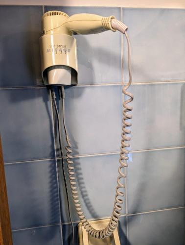 a blow dryer is hanging on a wall at Albergo Seggiovia in Scanno
