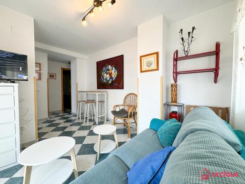 a living room with a couch and a table and chairs at La Marina in Oropesa del Mar