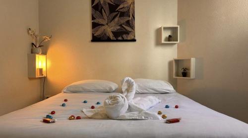 a bed with a bunny made out of towels at L'intemporel Central - Gare in Mâcon