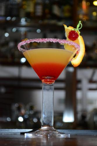 a cocktail with a red drink and a cherry at Musala Hotel in Borovets
