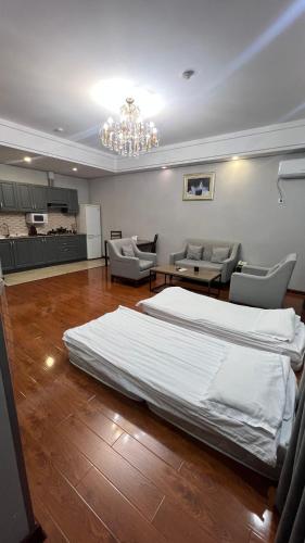 a large bedroom with a bed and a chandelier at Mountain View Residence Hotel in Almaty