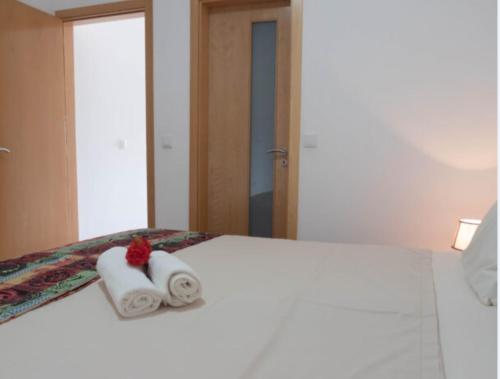 a hotel room with two towels on a bed at Casa Maria Apartments in Santa Maria