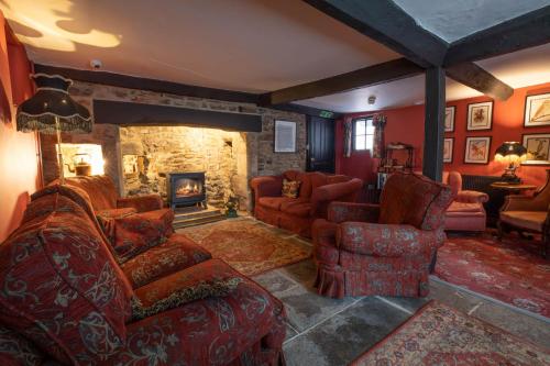 a living room with a couch and chairs and a fireplace at The Old Vicarage Hotel & Restaurant in Bridgwater
