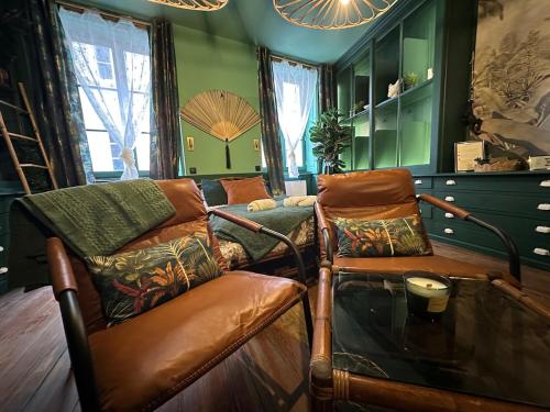 a living room with a couch and a glass table at LE JUNGLE-ROOM, Sauna, Hyper-centre in Mâcon