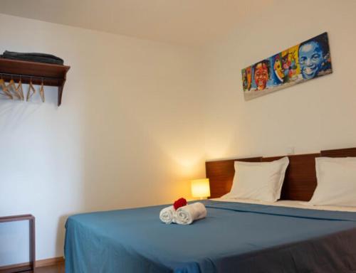a bedroom with a blue bed with a stuffed animal on it at Casa Maria Apartments in Santa Maria
