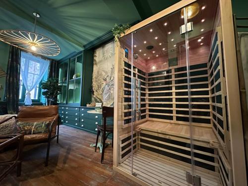 a jacuzzi tub in a room with a table at LE JUNGLE-ROOM, Sauna, Hyper-centre in Mâcon