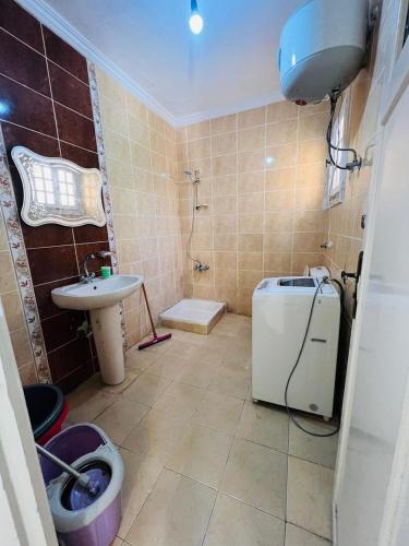 a bathroom with a sink and a toilet and a shower at Marseilia beach2 in Al Ḩammām