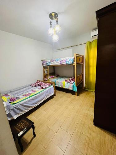 a room with two bunk beds and a wooden floor at Marseilia beach2 in Al Ḩammām
