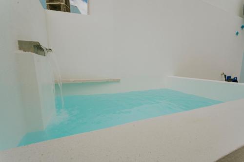 a swimming pool with blue water in a room at Best Houses 17 - Casa da Saudade in Atouguia da Baleia