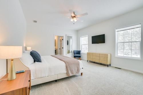 a bedroom with a bed and a desk and a tv at Walk to Beach Modern Retreat in Presque Isle! in Presque Isle