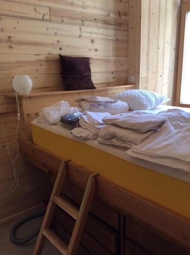 - un grand lit dans une chambre dotée d'un mur en bois dans l'établissement Huez village beautiful apartment, à Huez