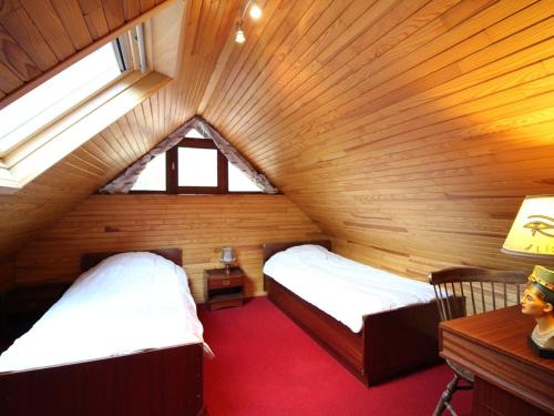 a attic room with two beds and a window at Mont-Dore : Chalet agréable avec WIFI pour 9 personnes - FR-1-608-88 in Le Mont-Dore