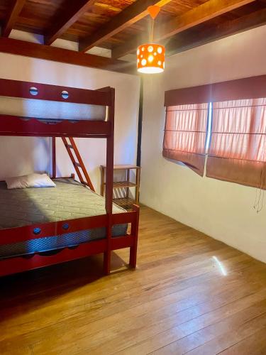 a bedroom with a bunk bed and a wooden floor at Casa de playa en Wakama in San Vicente de Cañete