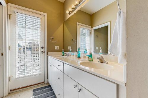 a bathroom with a sink and a mirror at Loggerhead - Leatherback #903 in Bethany Beach