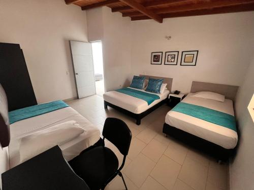 Postel nebo postele na pokoji v ubytování Hotel Quinta Avenida
