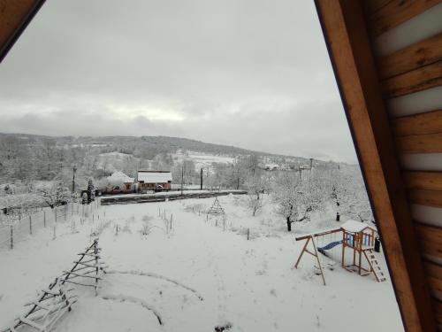 a winter view from a cabin with snow on the ground at Cabana Teo&Matei in Mihăeşti