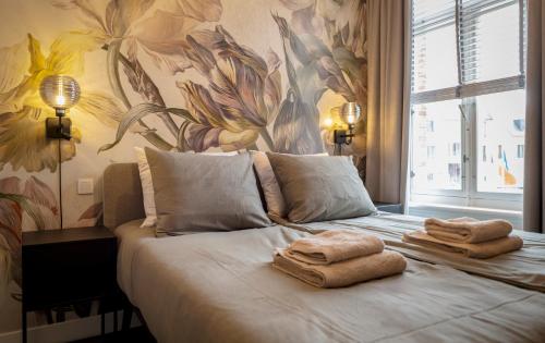 a bedroom with a bed with towels on it at Brownies & downieS Hotel Baarle in Baarle-Nassau