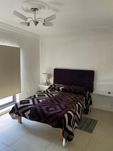a bedroom with a bed and a ceiling fan at Casa a 5 minutos caminando del centro historico in Zacatecas