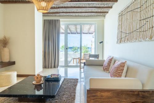 a living room with a couch and a table at Hotel Indigo La Paz Puerta Cortes by IHG in La Paz