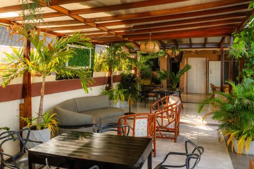 a patio with a table and chairs and plants at Hotel Marie Real Cartagena in Cartagena de Indias
