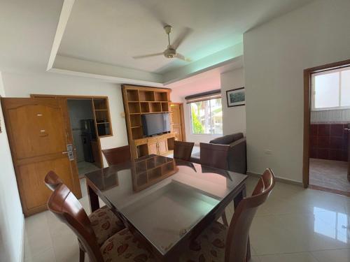 a dining room and living room with a table and chairs at Hotel Los Puentes Comfacundi in Girardot