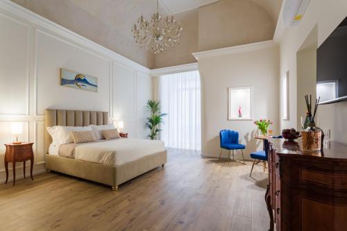 a bedroom with a bed and a table and chairs at Angiolina Suite in Naples