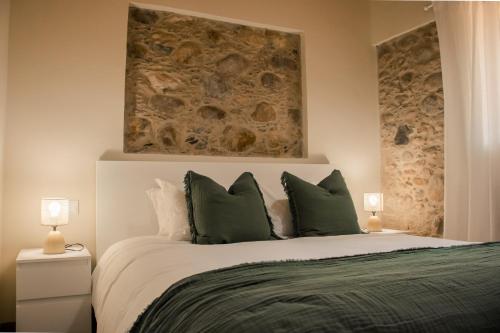 a bedroom with a large bed with green pillows at Quinta-lina de serpins in Serpins