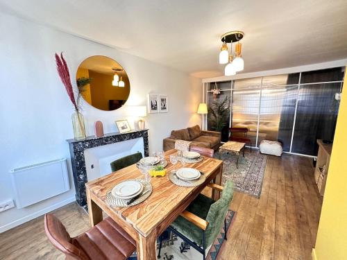 un salon avec une table et des chaises en bois dans l'établissement C Prieur de la marne hyper centre T3 grand confort, à Châlons-en-Champagne