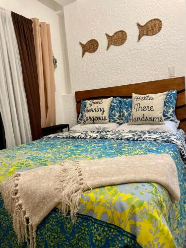 a bedroom with a bed with fishes on the wall at REEF HOUSE BACNOTAN White sand beach front with Private Swimming pool in Bacnotan