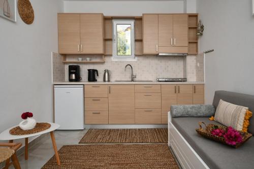 a living room with a couch and a kitchen at Paradise Apartments in Ferma