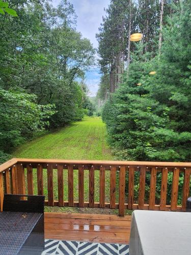 a wooden deck with a view of a yard at Loft in the Pines in Waupaca
