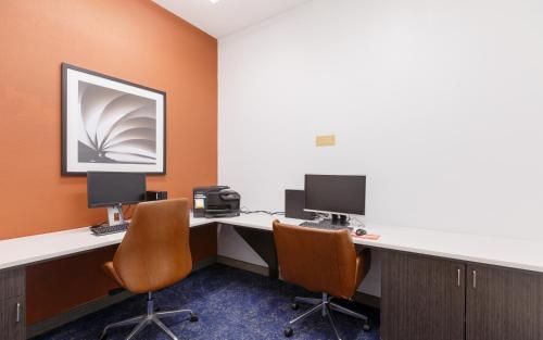 an office with two desks with two monitors and two chairs at Candlewood Suites San Marcos by IHG in San Marcos