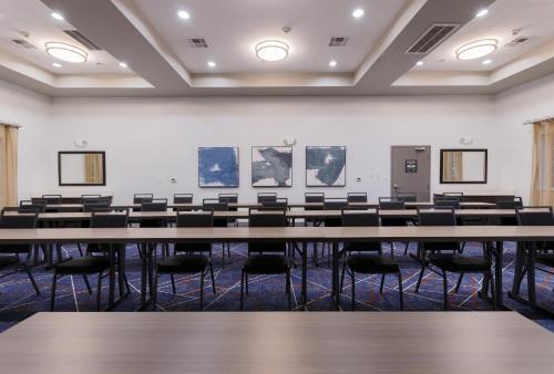 an empty lecture room with tables and chairs at Candlewood Suites San Marcos by IHG in San Marcos