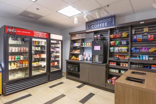 a supermarket aisle with a coffee shop withproducts at Candlewood Suites San Marcos by IHG in San Marcos
