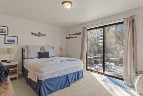 a bedroom with a bed and a sliding glass door at Idaho Treasure Hunt in Boise