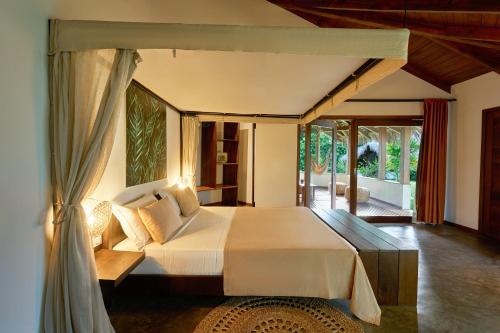 a bedroom with a large bed in a room at Loharano Lodge in Ambaro