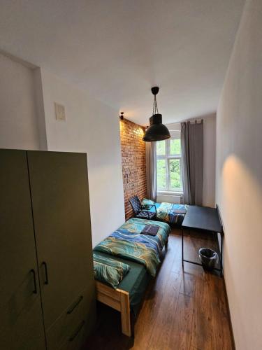 a living room with a couch and a window at 7Wygodny pokoj w centrum Wroclawia in Wrocław