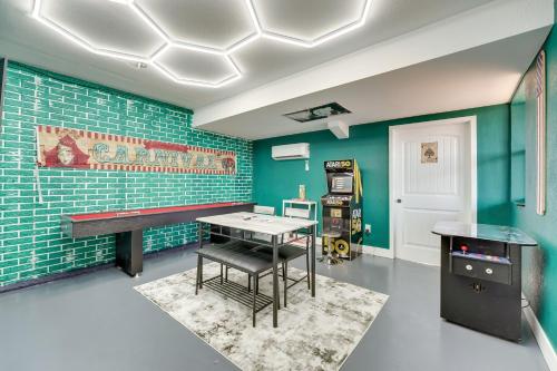 a room with a ping pong table in a room with green walls at Pet-Friendly Branson Area Home Hot Tub, Game Room in Reeds Spring