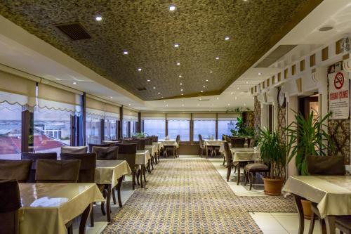 a restaurant with tables and chairs and windows at Grand Rosa Hotel in Istanbul