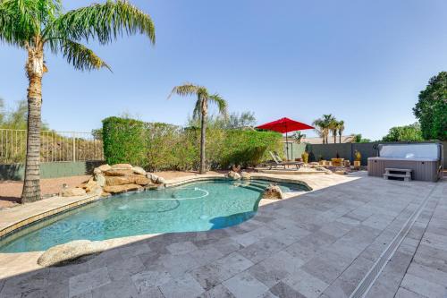 a swimming pool in a yard with a palm tree at 3 Mi to Usery Mtn Regional Park Poolside Paradise in Mesa