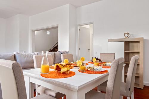 a dining room with a white table and chairs at Quinta Paraiso in Funchal