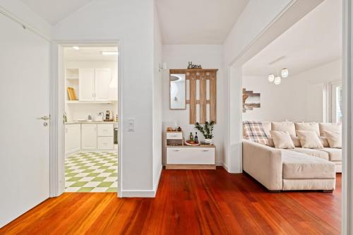 a living room with a couch and a kitchen at Quinta Paraiso in Funchal