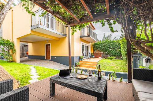 a patio with a table with a laptop on it at Quinta Paraiso in Funchal
