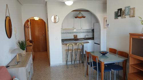 a kitchen with a table and some chairs and a counter at Capri 7 C Admer in San Blas