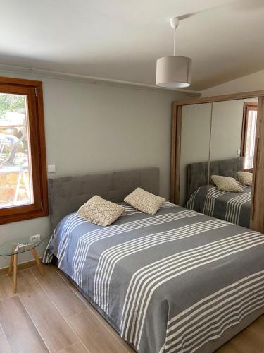 a bedroom with a large bed and a window at Villa Valeria in Solanas